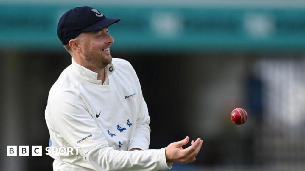 Ollie Robinson smiles as he tosses the ball to a team-mate