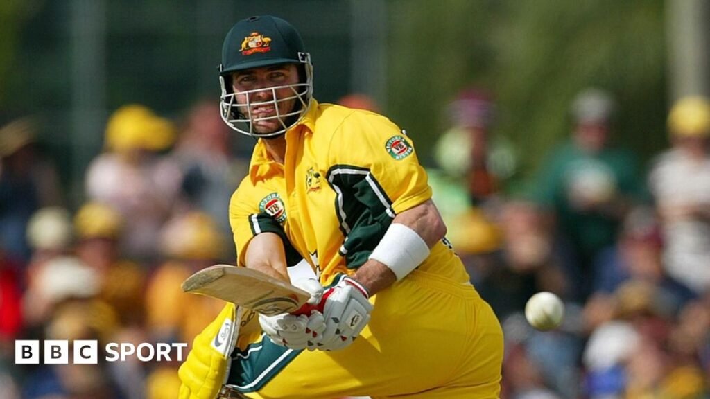 Damien Martyn stood on a beach at dawn, looking out to sea