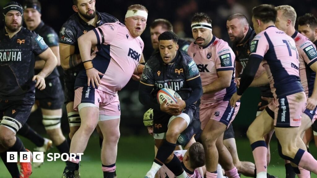 Keelan Giles of Ospreys has the ball surrounded by Cardiff players