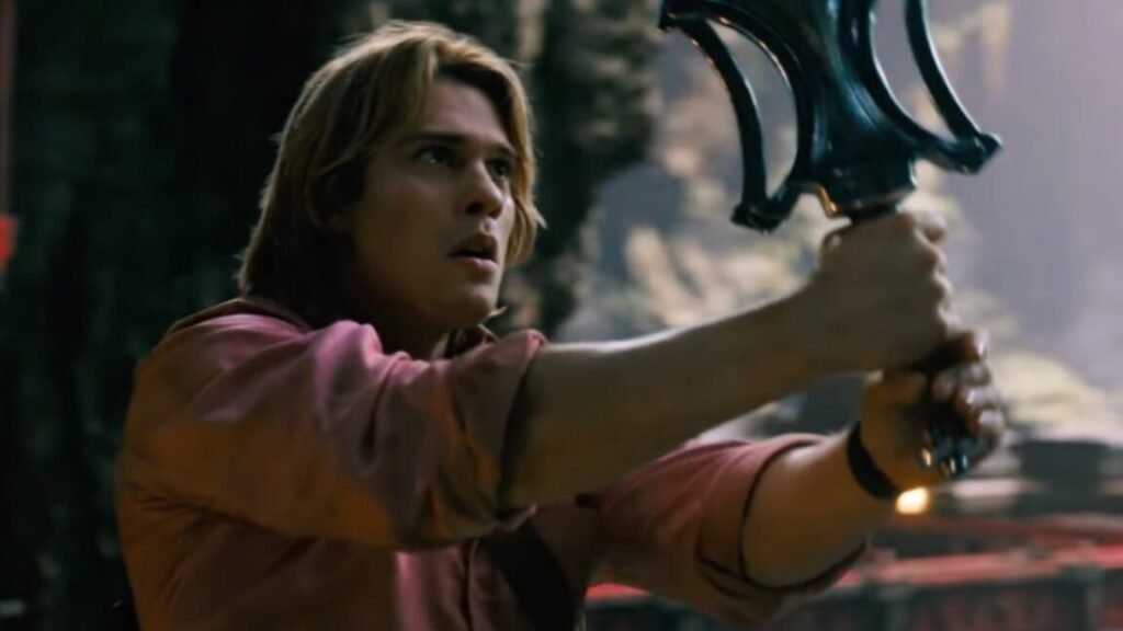 buff young blimp man in a reddish shirt holding a magic sword