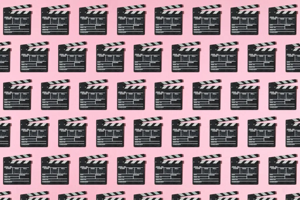 Wooden old movie clapperboard pattern with hard shadow on pink background. Concept of film industry, cinema, entertainment, and Hollywood.